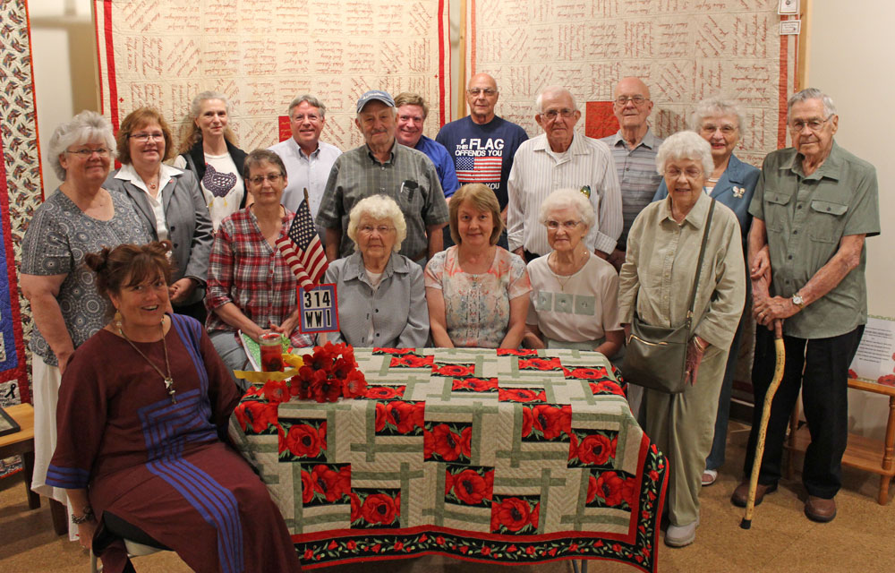 CAP: Relatives representing 314th soldiers at the July 15, 2018 gathering at the LCHS/Thomas T. Taber Museum were (Front): Krys Yarish, relative of John Shetler, Danville, Ralph Lyons, Millville, E. Frank Gardner, Unityville; Kay Bitner relative of William K. Campbell and Samuel English, Jersey Shore; Frances Bigger and daughter Susan Smith, niece and grandniece of E. Frank Gardner of Unityville; Helen Meyer, daughter of Harold Lauchle of Huntersville; Mary Ann Williams, daughter of Homer M. Rood of Morris Run. (Row 2): Carol Shetler, relative of the aforesaid Lyons and Gardner; program speaker Nancy Schaff, granddaughter of John Blazosky of Port Matilda; Patty Lane, granddaughter of James Lane of Dushore; William Nicholson, grandson of Evan Rosser, Williamsport, William Olson, son of Carl Olson of Duboistown; Thomas Nicholson, grandson of aforesaid Rosser; Don Baylor, nephew of Ralph Baylor of Mooresburg; Leigh Rood, son of Homer Rood, Morris Run; Ray Confer, son of Raymond Confer of Muncy; Evelyn Seaman, daughter of Otto Hess of Morris; and Paul Seaman, nephew of Samuel Seaman of Bradford.