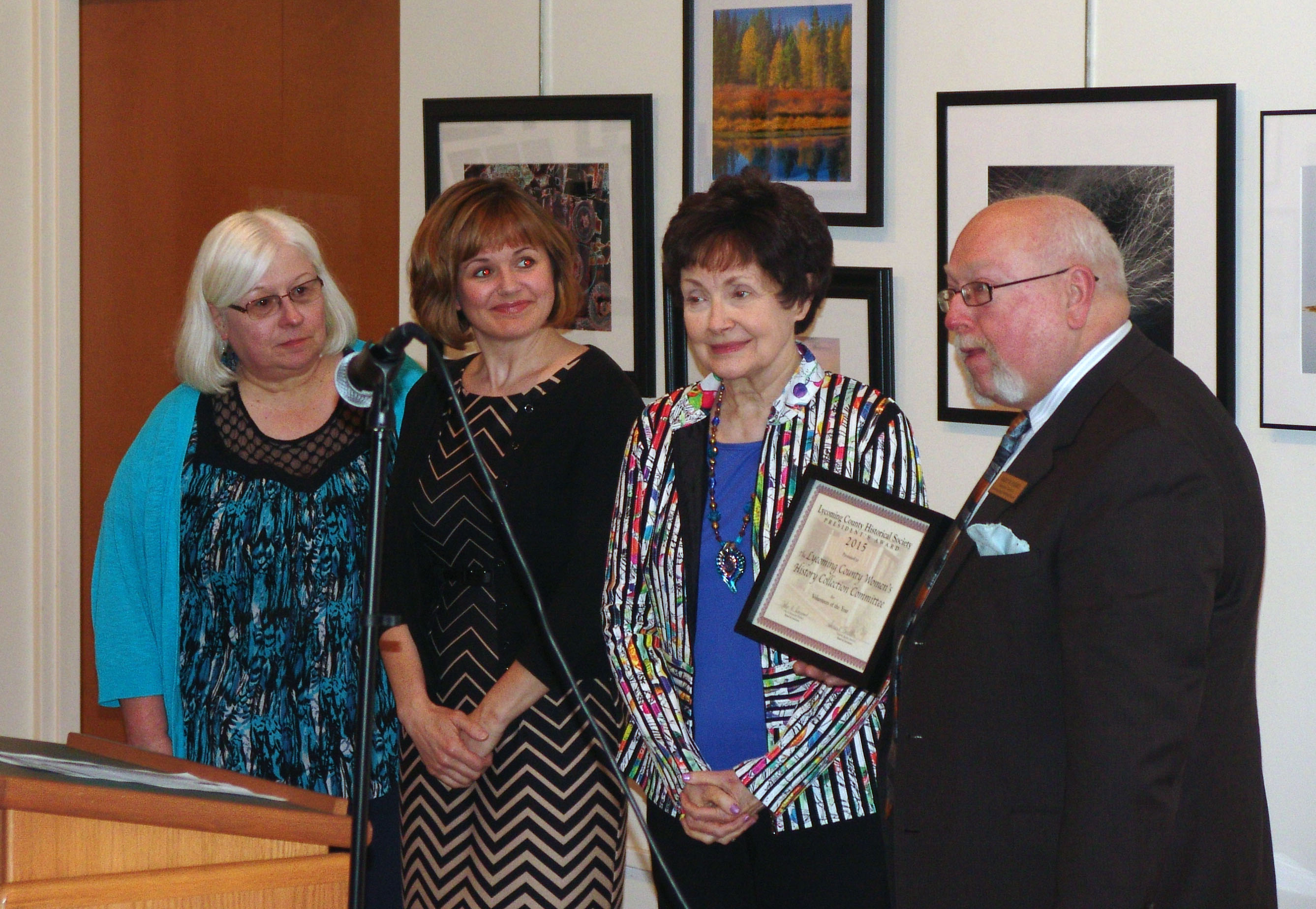 Director Gary Parks presenting the Volunteer of the Year Award to representatives of the Lycoming County Women’s History Collection Committee; from left: Helen Yoas, Alison Gregory, Janet Hurlbert